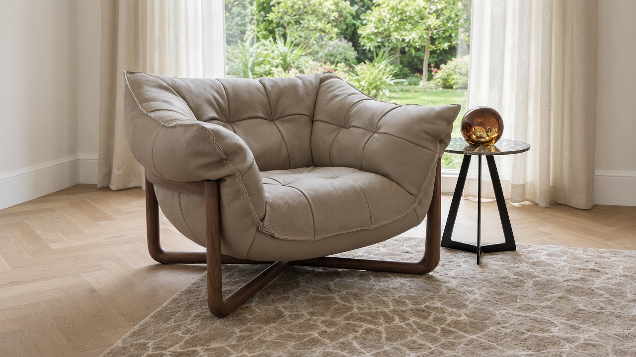 Cierre Donald armchair in taupe leather with crossed solid walnut base, styled in a sunlit living room